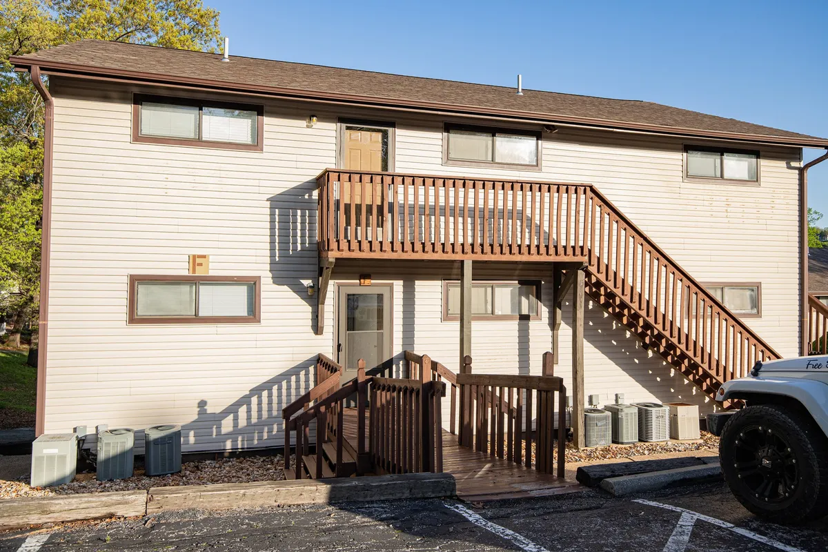 The exterior view includes a staircase, entrance door, and balcony. The balcony setting hints at opportunities for quiet mornings or social gatherings, with a friendly and relaxed atmosphere.