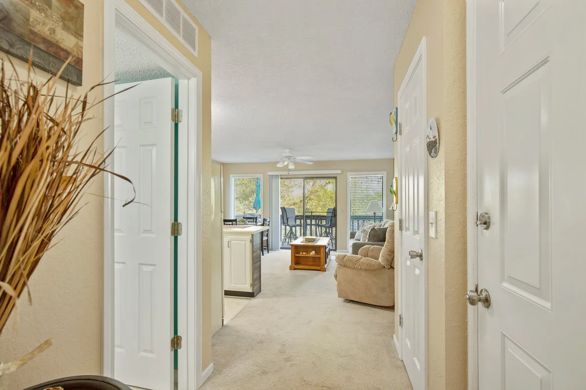 The living area is filled with morning sunlight streaming through large windows, creating an inviting atmosphere perfect for relaxing after a day of activities. A comfortable sofa, coffee table, and seasonal touches make this space ideal for family gatherings and planning the next outing.